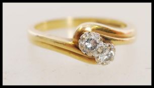 A 20th century hallmarked 18ct gold crossover ring with two central diamonds totalling approximately