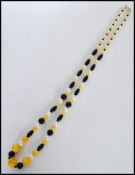 A 20th century long necklace set with hard stones and pearls with a stamped 925 silver lobster