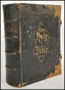 A 19th century leather and brass bound bible having tooled notation - National Comprehensive