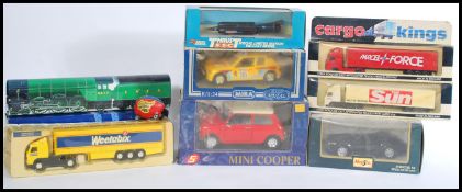 A collection of boxed scale die cast models to include a Peugeot 205 rally car, MIni Copper,