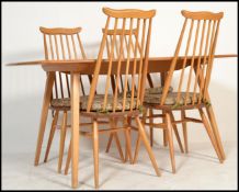 Ercol - A vintage 20th century blonde beech and elm wood refectory plank dining table being raised