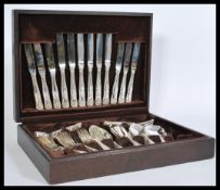 A canteen of Newbridge silver plated cutlery in a wooden case, having a six place setting. Wooden