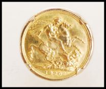 A large 585 / 14ct gold sovereign ring. The sovereign dated 1920 and faced St George & Dragon to