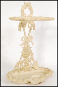 A vintage 20th century white painted cast iron walking stack / umbrella stand with decorative bows