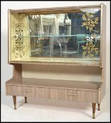 A 1960's Italian melamine / formica upright china display cabinet having lacquered finish raised
