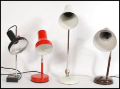 A group of four vintage retro 20th century anglepoise desk lamps. Three raised on circular bases