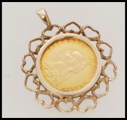 A United Kingdom Victoria (1837-1901) 22ct gold 1887 half sovereign young head shield back, set