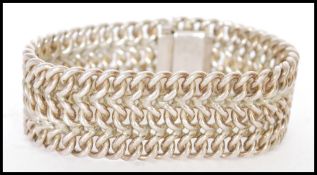 A 20th century sterling silver cuff bracelet stamped 925 with mesh design. Weight approx 73g.