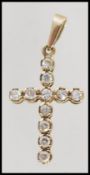 A hallmarked 9ct gold crucifix pedant set with white stones. Weight 2.1g. Measures approx 3.5cms.