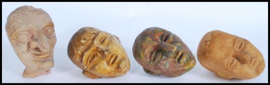 A collection of four vintage 20th Century sculptured puppet heads, to include Plasticine and clay