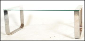 A retro mid 20th century tubular chrome and glass coffee table in the manner of Pieff, the glass top