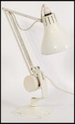 A vintage retro 20th century industrial Hadrill Horstmann desk lamp raised on a square base with