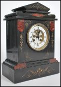 A 19th century Victorian slate and rouge marble mantel clock with enamelled roman numeral chapter