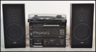 A retro 1980's AKAI hi-fi system in black complete with the speakers. The system with record deck
