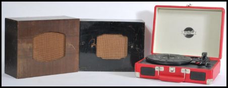 A Retro portable red leatherette cased record player with two vintage 1930's decorative gloss