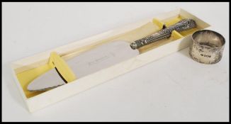 A silver hallmarked handled cake knife complete in original box along with a silver hallmarked