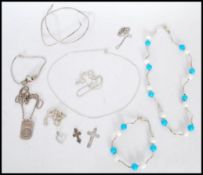 A selection to silver jewellery to include a square link necklace, a necklace with blue and white