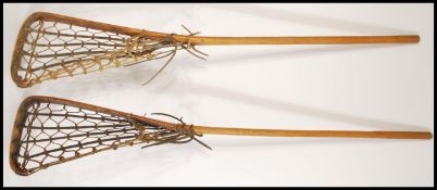 A pair of vintage mid 20th Century Lacrosse rackets together with a collection of similar aged