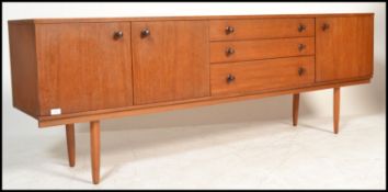 A vintage 20th Century teak wood sideboard, three cupbards with a central bank of three drawers,