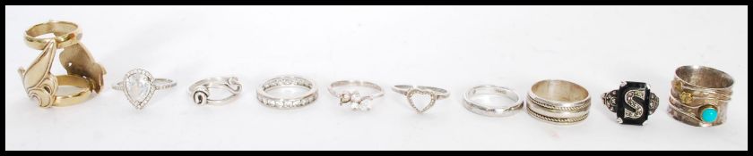 A collection of silver rings to include a signet ring with inset black stone marked 'S', a silver