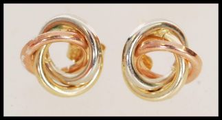 A pair of 9ct gold earrings with overlapping knot design weighing 0.7g