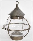 A vintage 20th Century Georgian revival porch lantern, the glass shade of bulbous form with a