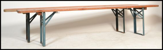A pair of mid 20th Century Industrial factory work benches. Each of panelled wood with folding metal