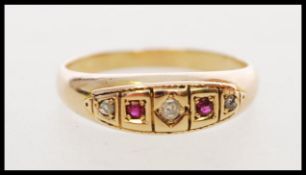 A hallmarked 19th century Victorian 15ct gold ring set with red stones, a white sapphire, a rose cut