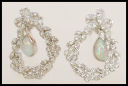 A pair of stamped 925 silver drop earrings with garland form drops with white stones and inset