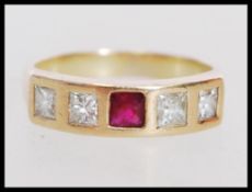 A 20th century 18ct gold ring set with four square cut diamonds and a central square cut ruby.