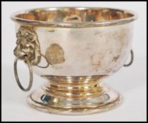 A silver hallmarked pedestal bowl, twin Lion mask hoop handles, Sheffield assay mark, with date