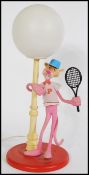 A vintage retro 20th century Pink Panther lamp featuring the iconic character in tennis attire stood