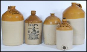 A collection of five early 20th Century advertising point of sale stone ware flagons of local