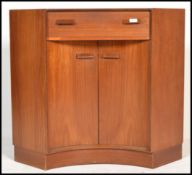 A 1970's G-Plan syle concave teak wood corner desk secretaire having fall front drawer pull put desk