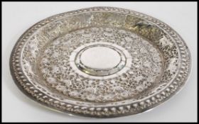 A silver believed Raj period / Indian dish with geometric design with elephants and ox in relief