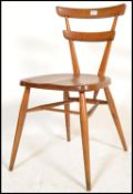 A mid century Ercol beech and elm green spot dining chair by Lucian Ercolani. Raised on turned
