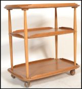 A  vintage 20th century Ercol 3 tier butlers serving buffet trolley. Blonde elm tiers raised on