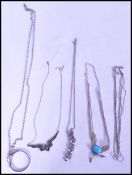 A selection of silver jewellery to include a multi chain necklace with inlaid blue stone, a collared