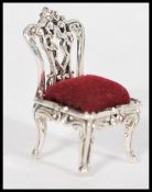A stamped 925 silver pincushion in the form of a Chippendale style chair. Weight 10.1g. Height 3.5