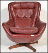 An original 1960's retro vintage button back swivel egg type chair, raised on a four point splayed