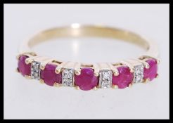 A 20th century hallmarked 9ct gold ring set with diamonds and rubies. Hallmarked Birmingham.