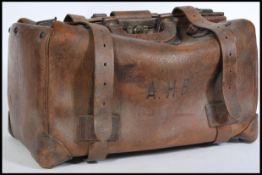 A vintage early 20th century leather Gladstone doctors bag having carry handle to top and lock to