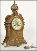 A 19th Century French gilt metal eight day mantel clock striking on a bell, the case ornately cast