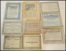 A collection of vintage mounted and glazed share certificates dating from 1913 to include Societe