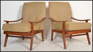 A pair of retro 20th Century open framed teak wood lounge / fireside armchairs each being