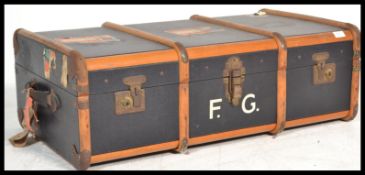 A vintage 20th century blue and canvas bound steamer trunk case having hinged centre with clasps and