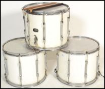 A group of three Everplay extra regimental  parade side drums, in white, with chrome style trim,
