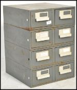 A set of four vintage retro 20th century industrial stacking filing cabinet units of typical form