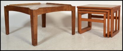 A retro 1970's Danish teak wood and chequer tile top coffee table of squared form having gallery