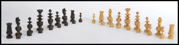 A set of turned box wood and stained box wood chess pieces in the manner of Staunton, the Kings